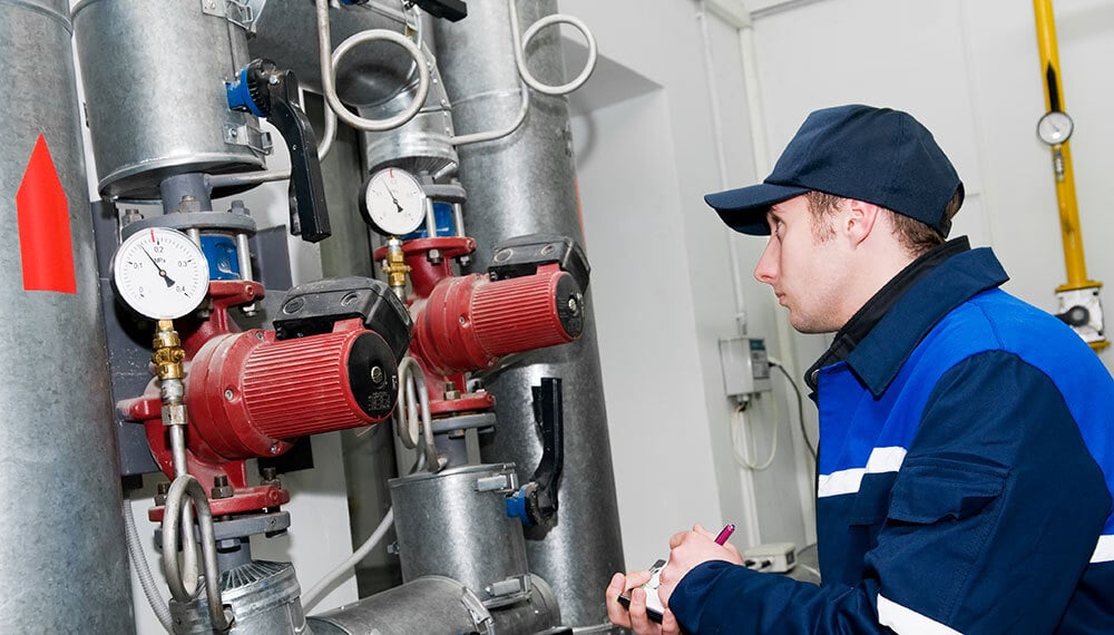 Air Control & Development engineer performing maintenance on HVAC equipment