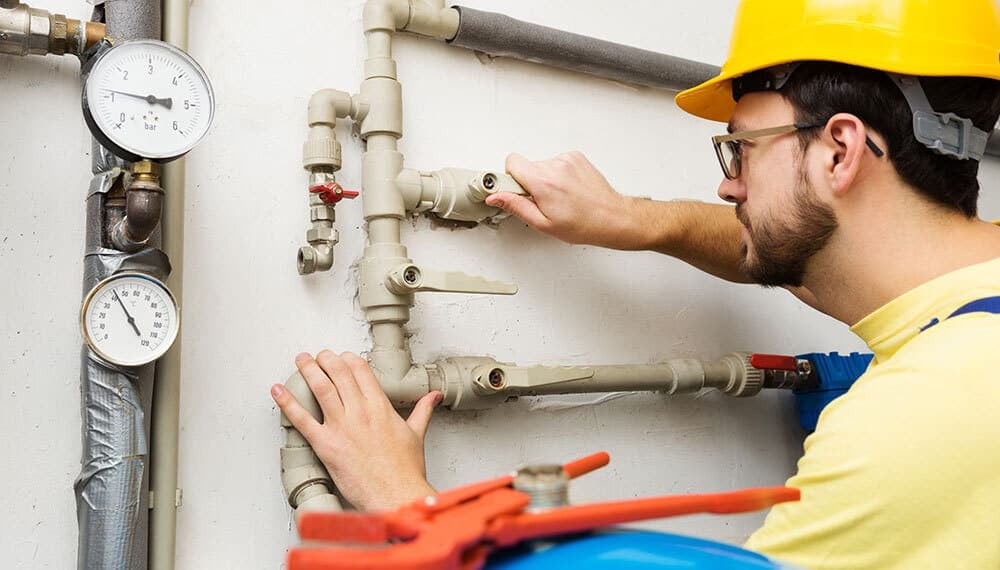 Drainage engineer repairing pipes