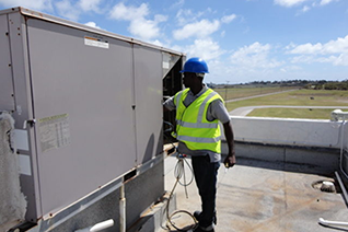 HEG Engineering Services engineer repairing HVAC equipment on a roof