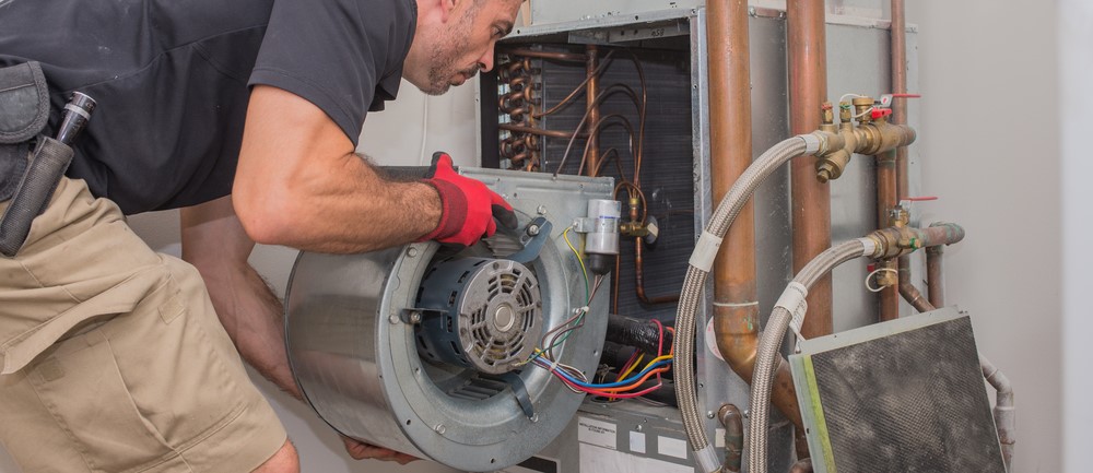 HLA Services engineer repairing HVAC equipment